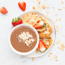 second breakfast in a pescovegetarian box diet - cottage cheese pancakes with cocoa sauce and strawberries